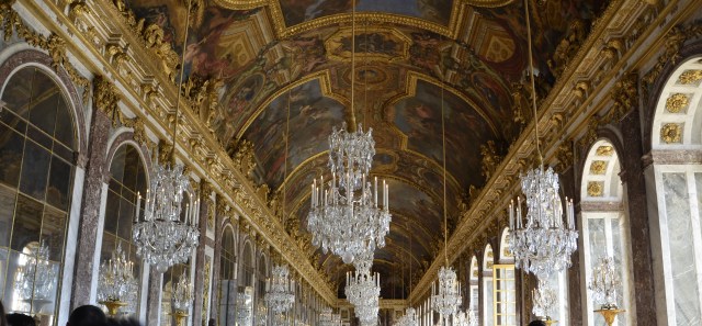Hall of Mirror is cramped with artistic arches, large vaulted windows, chandeliers, gilded sculptures and impressionistic art covered ceiling through entire 240 ft. length  